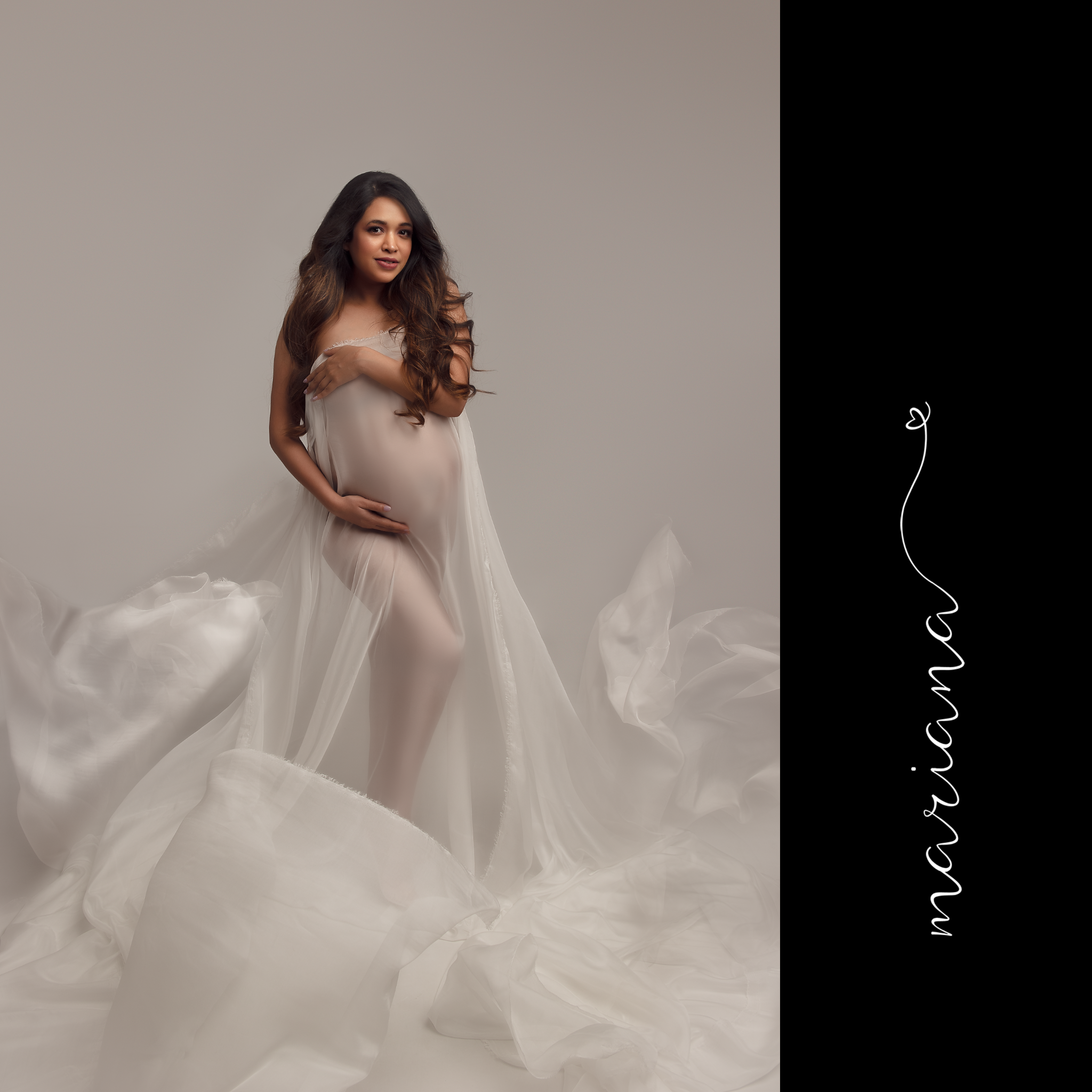 Maternity portrait with flowing ivory fabric