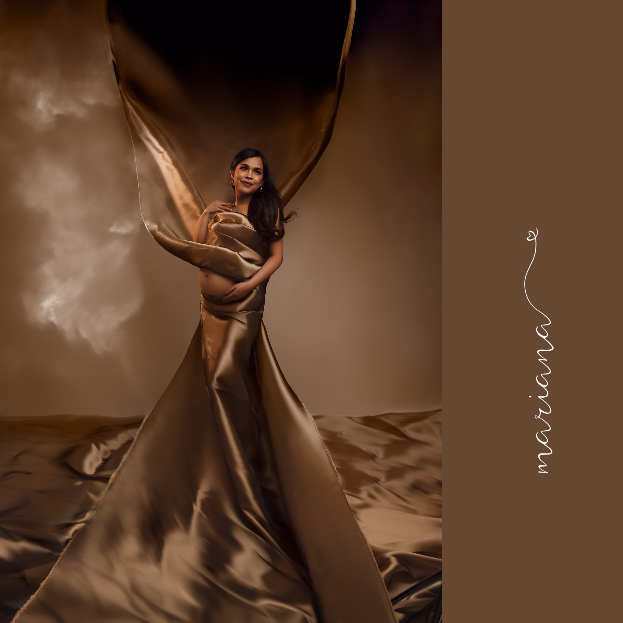 Maternity portrait in flowing champagne satin