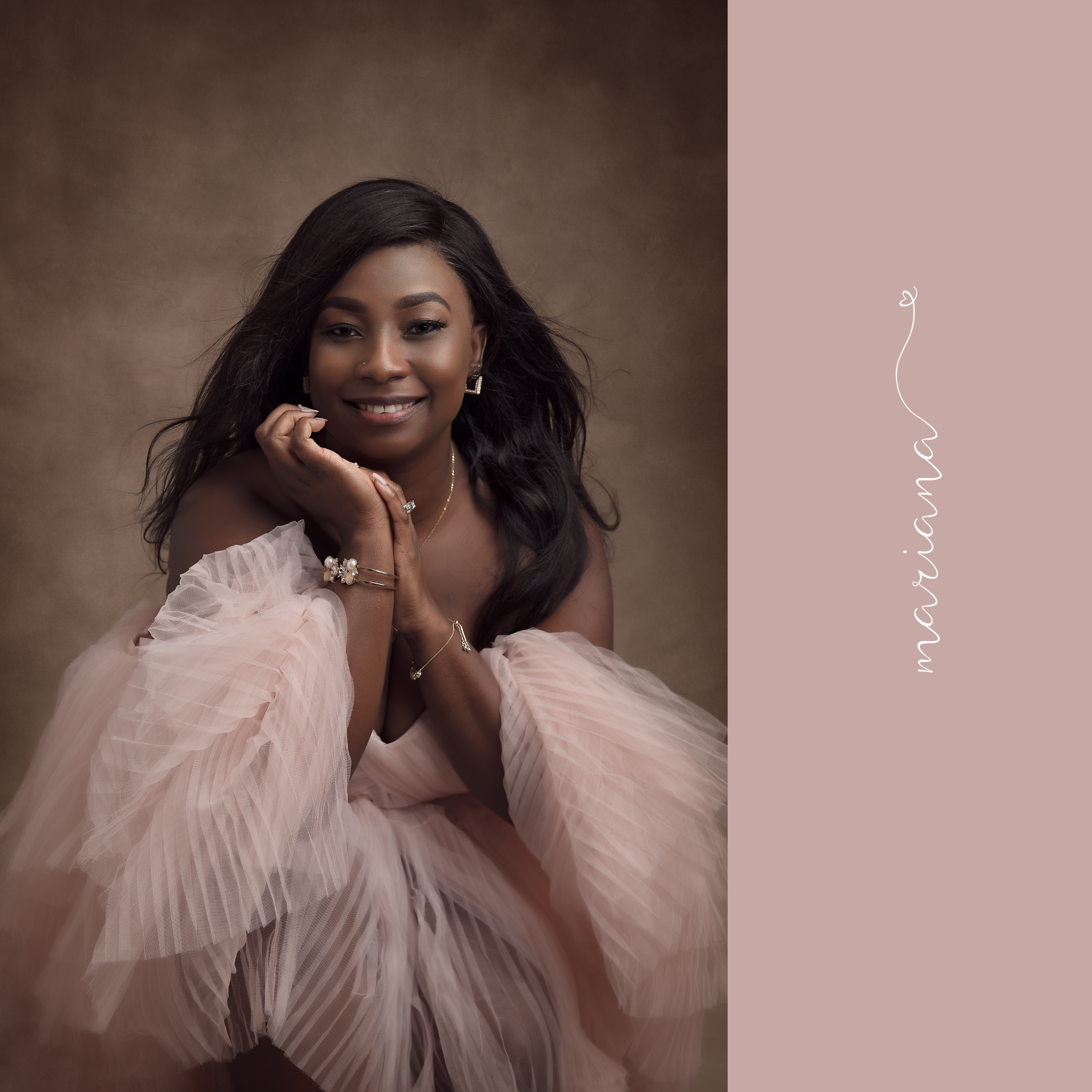 Smiling woman in soft pink tulle against a warm brown backdrop