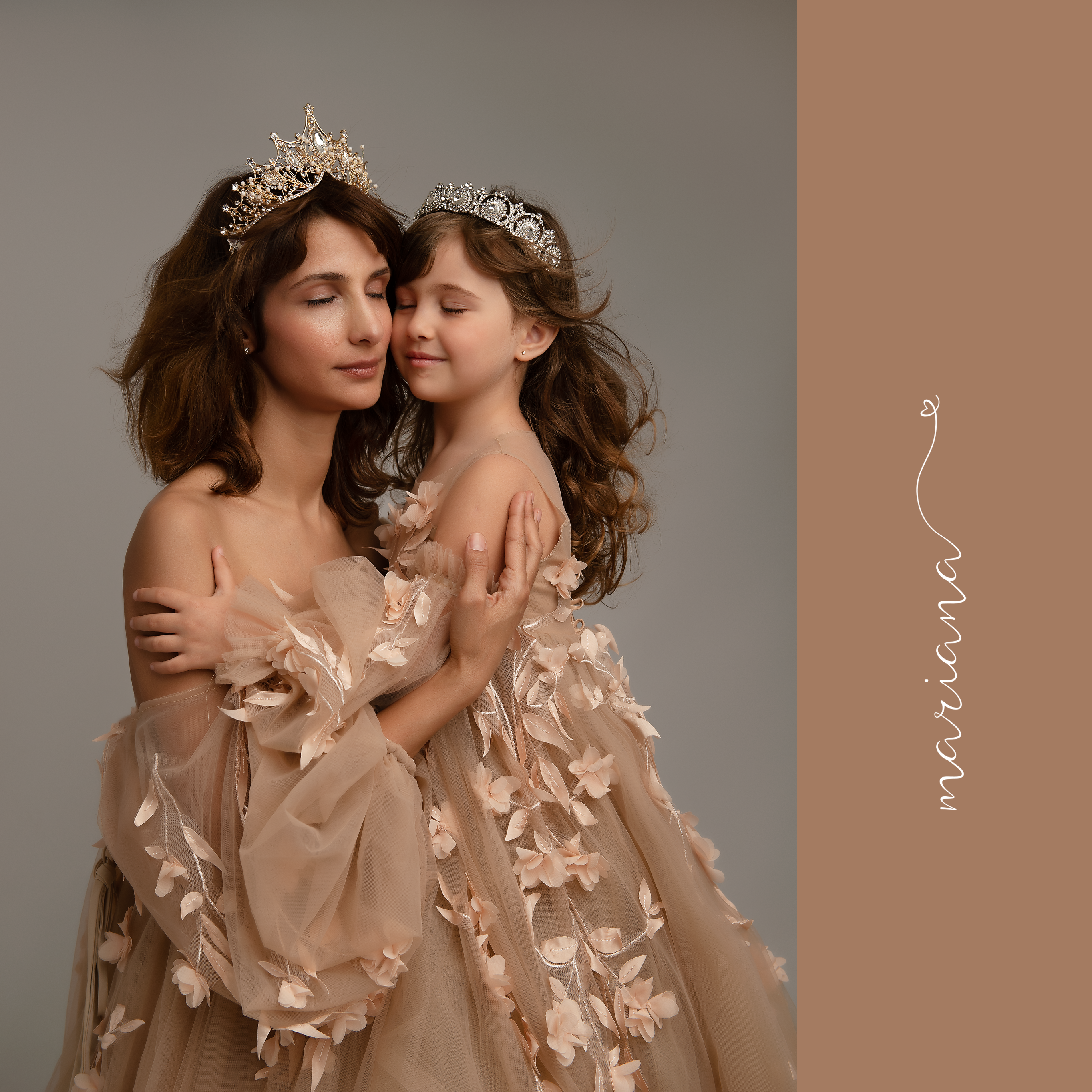 mom and daughter with beige matching dresses hugging with closed eyes